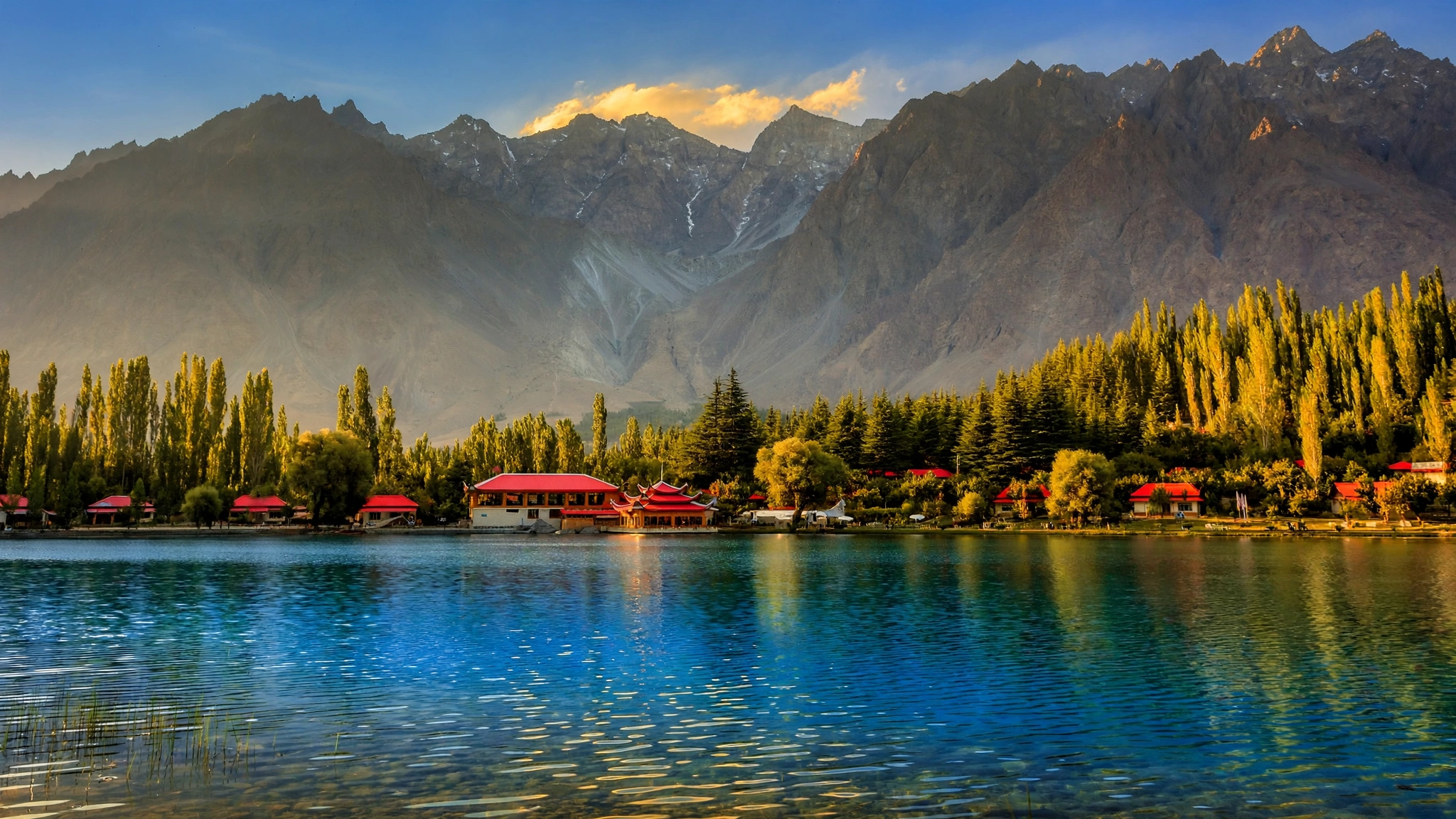 Shangrila Lake with red-roofed resort buildings and poplar trees, Skardu, Pakistan